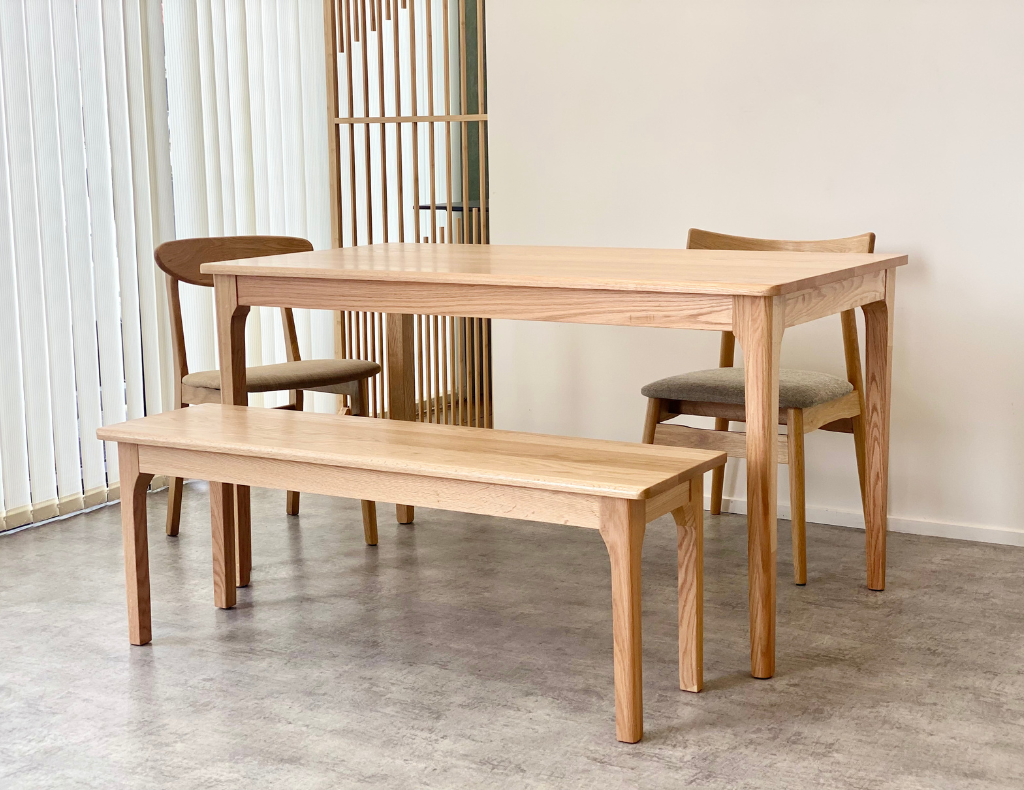 Peninsula Oak Dining Table- set with same range bench and oak dining chairs. Natural varnishing.